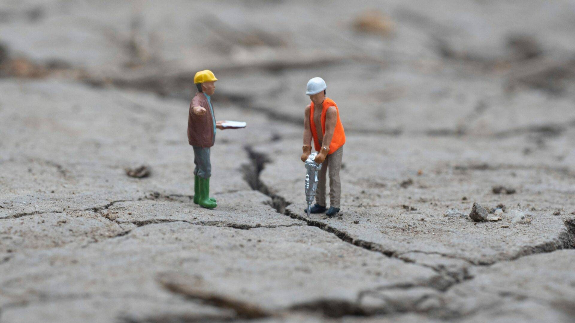 Workers on Cracked Concrete tilt shift concrete workers
